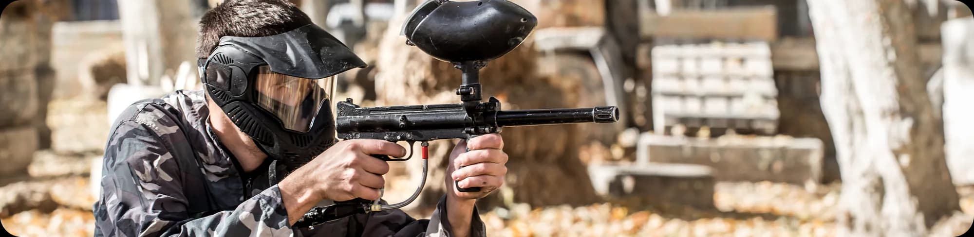 Paintball player aiming a marker during a game
